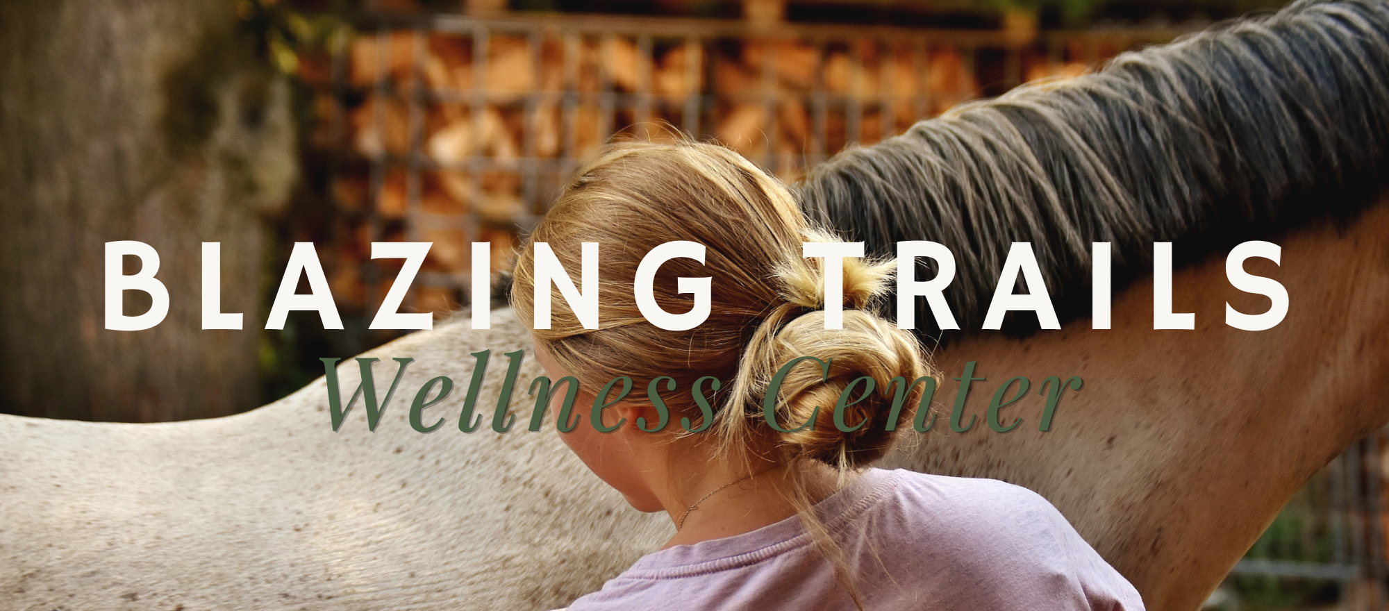 Blazing Trails Wellness Center - Woman with horse in therapeutic setting